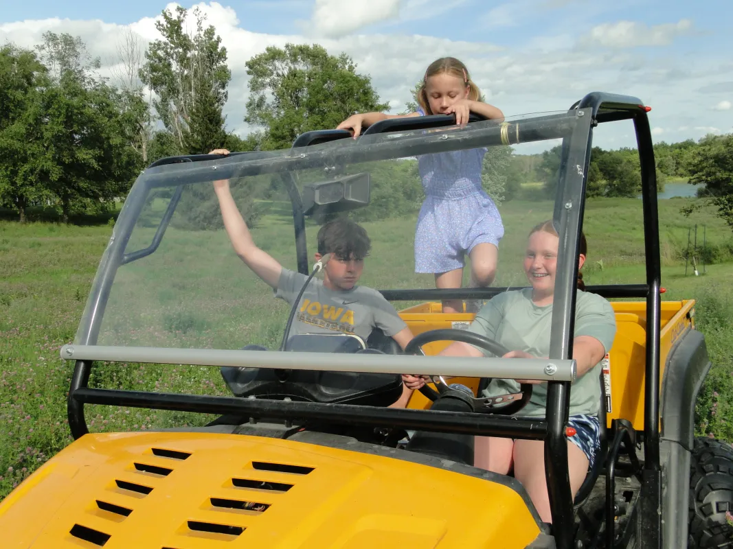 Three children sitting incorrectly in an UTV