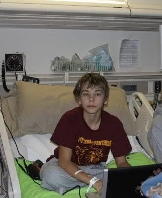 Dillyn Mumme sits in his hospital room during his first week of treatment for high-risk acute lymphoblastic leukemia at University of Iowa Health Care Stead Family Children’s Hospital.