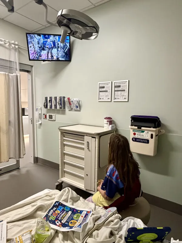 A pediatric patient at UI Health Care Medical Center North Liberty watches NASA astronaut Chris Williams answer questions from aboard the International Space Station.