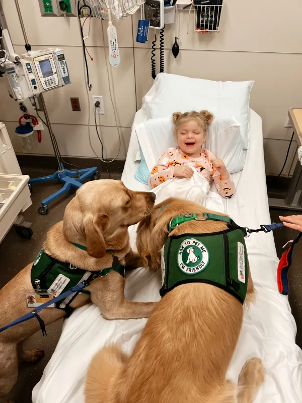 Kid Captain Harlow Taube and facility dogs, including Nacho and Corrin