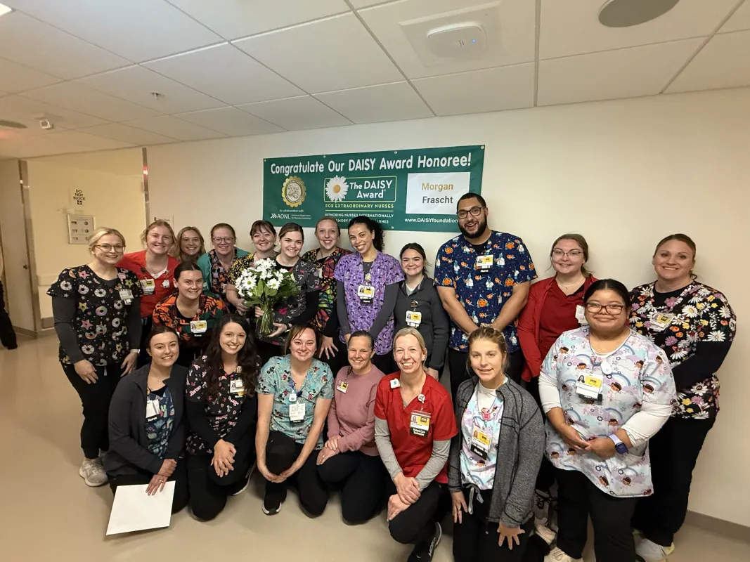 Colleagues celebrate Morgan Frascht receiving her DAISY Award.