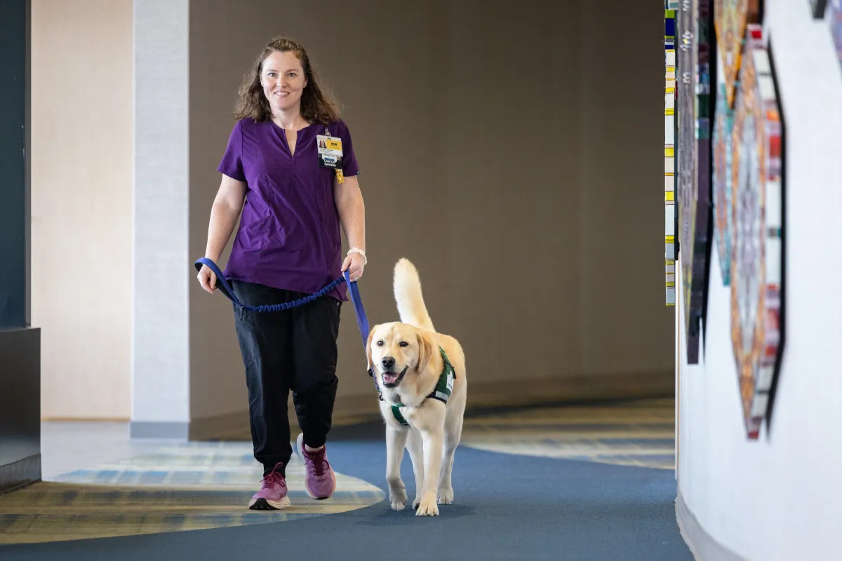 Facility dogs Caitlyn Clark and Nacho at Stead Family Children’s Hospital on Thursday, Sept. 24, 2026.