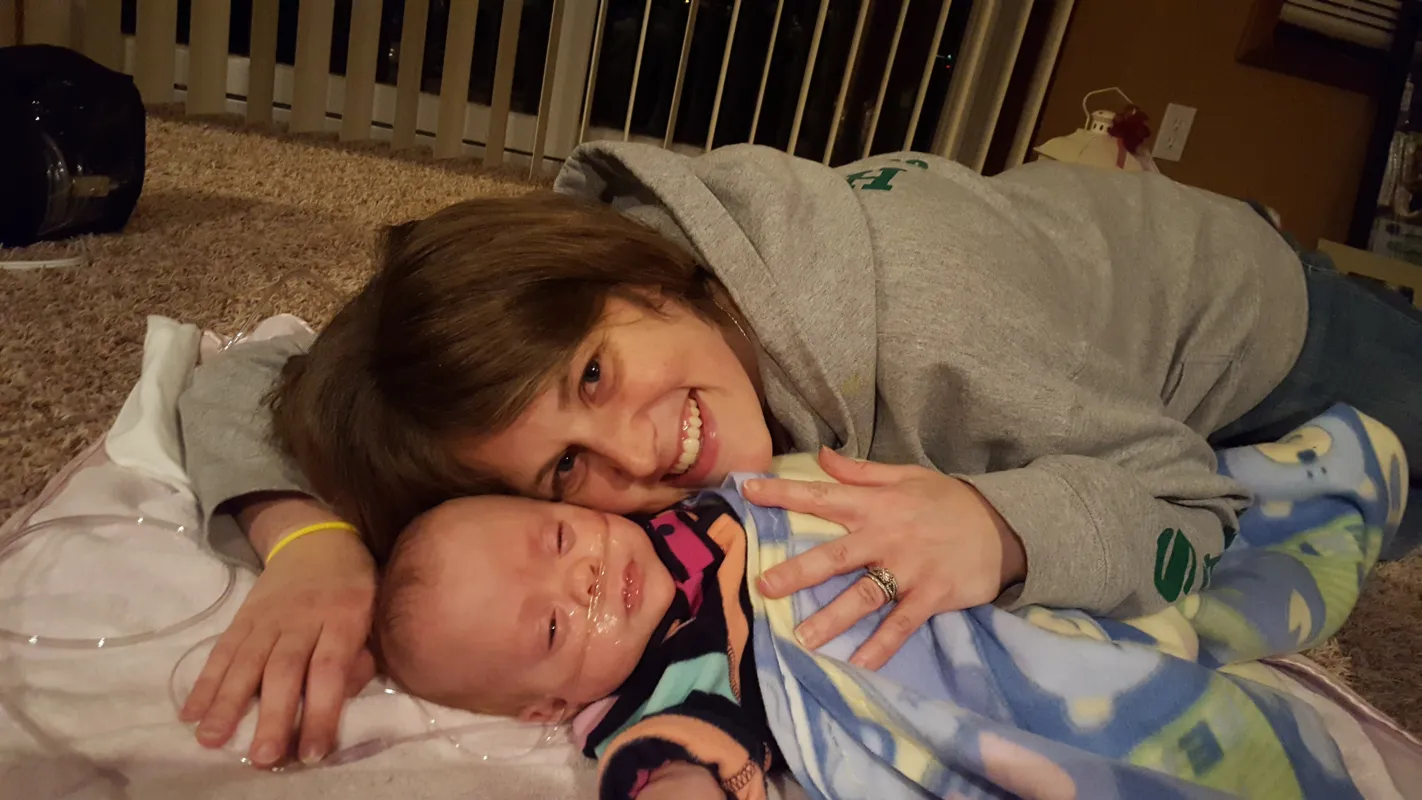 Kid Captain Eliana Gaul as an infant held by her mom