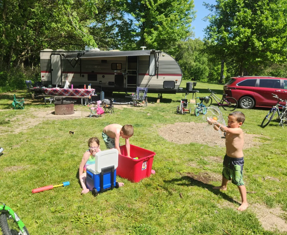 Kid Captain Eliana Gaul camping with her brothers