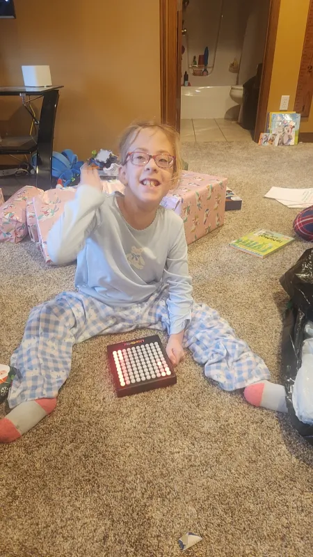 Kid Captain Eliana Gaul opening a present