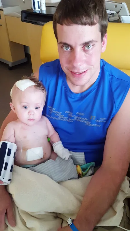 Kid Captain Eliana Gaul as an infant held by her dad