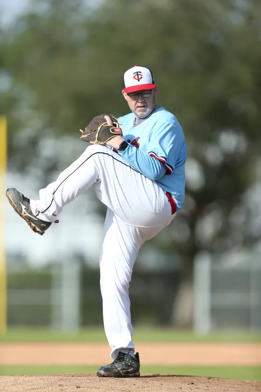 Ron Watson pitches a baseball