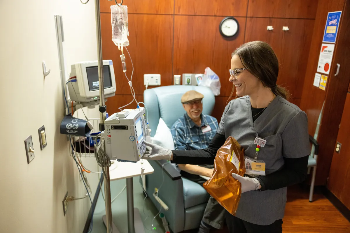 Staff nurse Kiley Eastwood, RN ADN, prepares an infusion of ascorbic acid (Vitamin C) for Garry Buettner at Holden Comprehensive Cancer Center on the UI Health Care university campus on Wednesday, Dec. 3, 2025. Buettner, PhD, is a professor in Radiation Oncology, spent decades of his career researching the cancer-fighting potential of intravenous vitamin C and now receives it as part of his treatment.