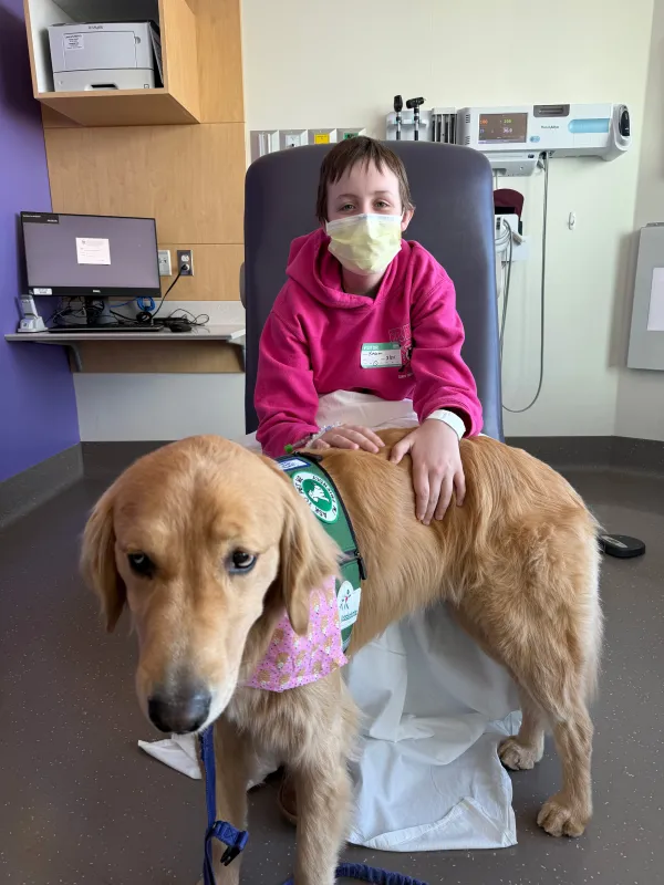 Kid Captain Kaelyn O’Brien and a therapy dog