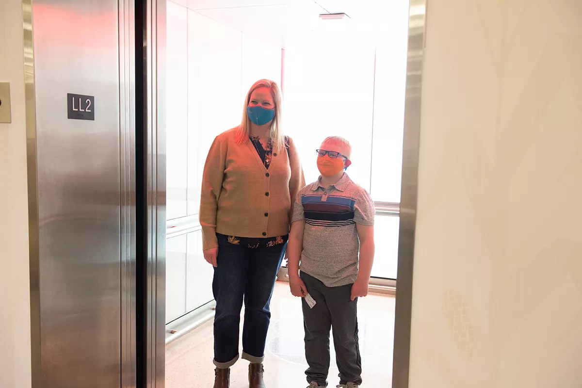 Mother and her child inside an elevator at UI Stead Family Children's Hospital