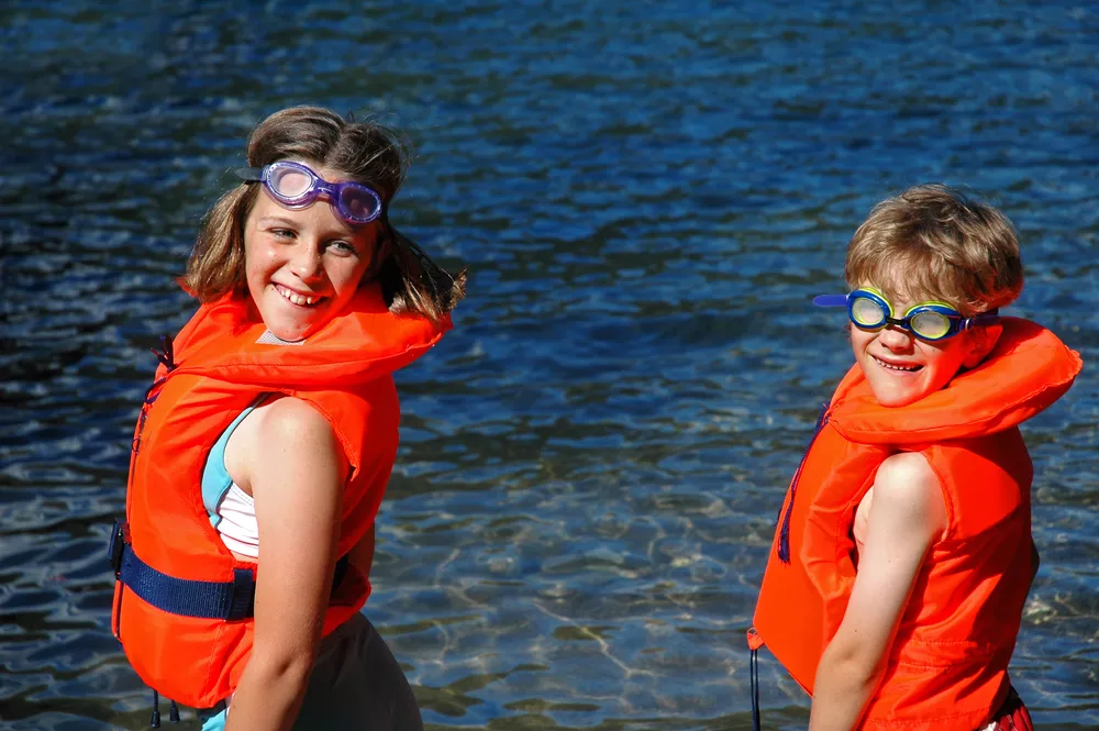 Children wearing life jackets at the beach