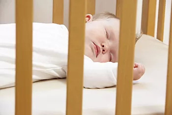 Infant sleeping in crib