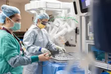 Nurse Megan Mulholland, RN, BSN, joins Julie Delancey, RN, in preparing an OR and robot for a robotic prostatectomy.