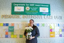 Rachel Gage BSN, RN, receiving her Daisy Award in the PICU.