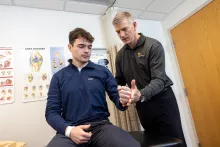 Brian Wolf with shoulder patient at UI Sports Medicine on Wednesday, April 5, 2023. Patient consent on file.