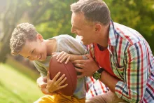 Family playing outdoor football