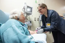 Molly Gore, ADN RN, with infusion patient at Holden Comprehensive Cancer Center on the UI Health Care university campus on Monday, May 5, 2025. Patient consent on file. 