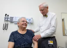 UI Health Care orthopedic surgeon James Nepola, MD, examines the shoulder of Martha Widmer of rural Wayland, Iowa, during a recent clinic appointment.