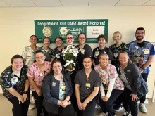 Pediatric nurse Zoie Burton, BSN, RN, receives a daisy award.