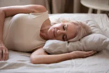 Women sleeping on a bed.