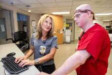 Steve Hoff and Jolyn Schneider met in 1992 when Steve was hospitalized as a child with burn injuries, and Jolyn was on a job shadow in the burn unit. Jolyn, now a nurse manager on the unit, later reconnected with Steve and hired him as a patient care technician. Photographed on Wednesday, Sept. 17, 2025. 