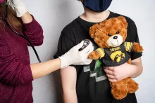 Child holding a stuffed bear