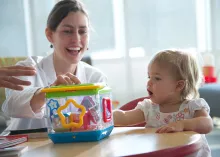 Lori Christensen, MD, plays with a patient