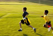 Two boys playing flag football