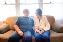 Jim and Roberta Carver sitting together on their couch