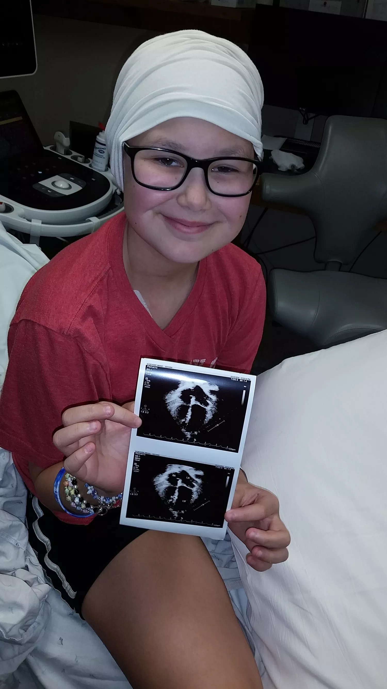 Brandi holds a photo of her scans