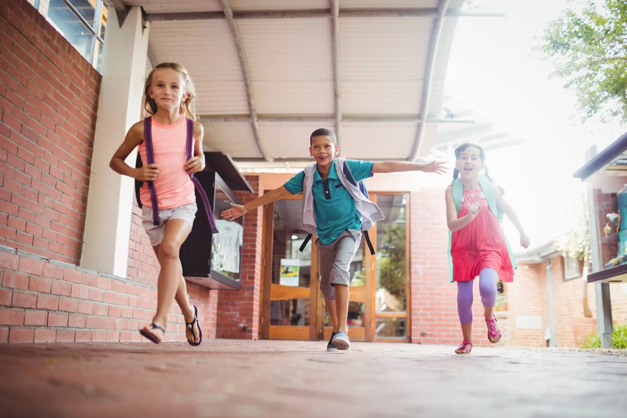 children running next to elementary school photo