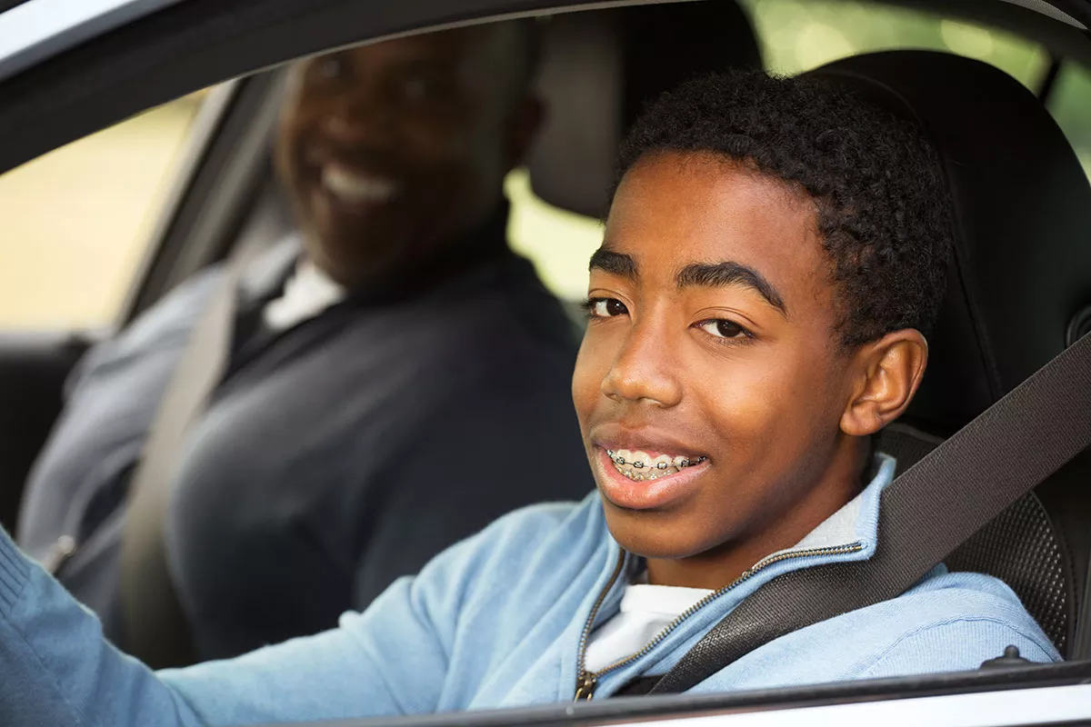 father and teen son in a car