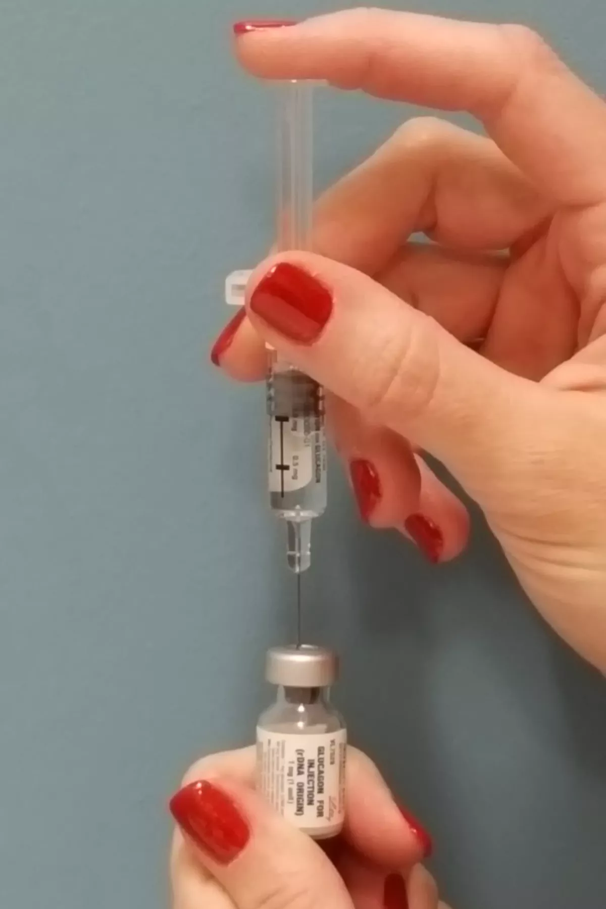 inserting needle into glucagon, photo