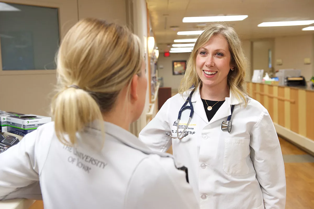 Nurses conferring in hallway