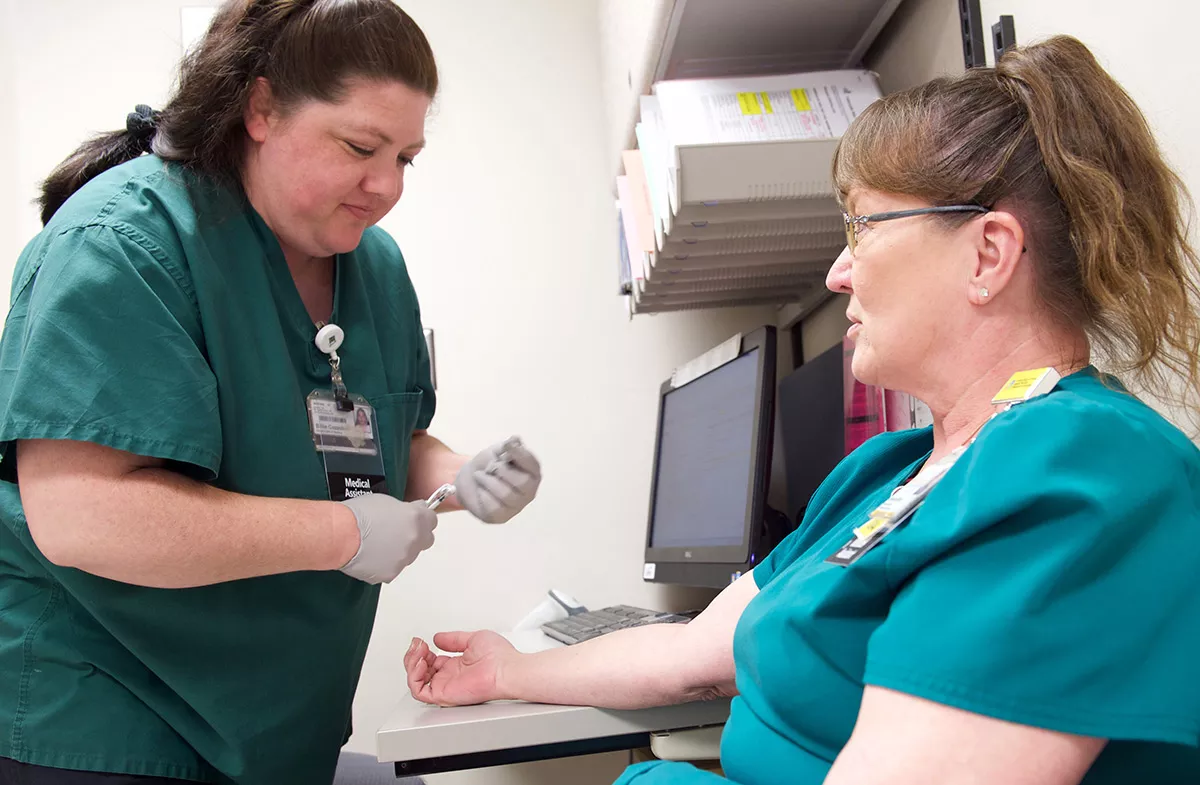 Nurse preparing to give patient an immunization.