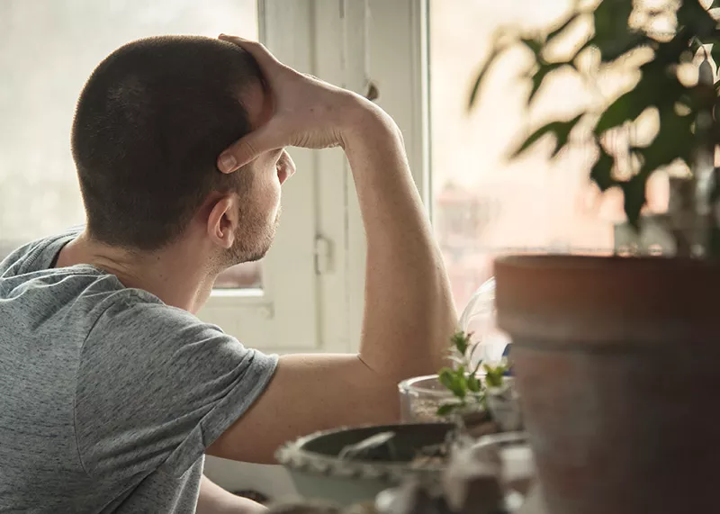 Man looking out a window