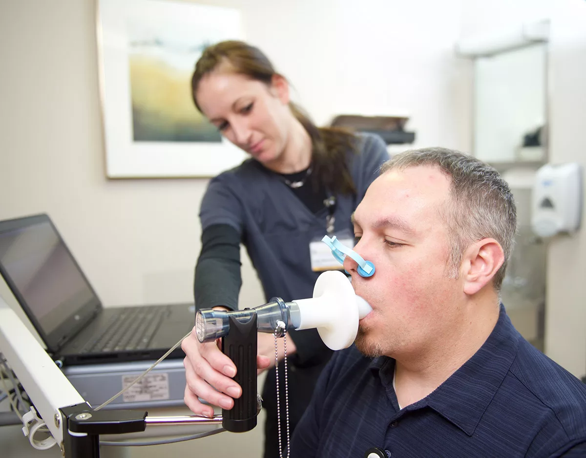 Technician conducting a breathing test.