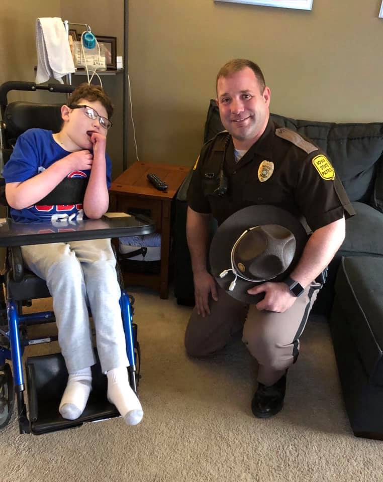 Caleb Helland and the Iowa State Patrol trooper who delivered his medication 