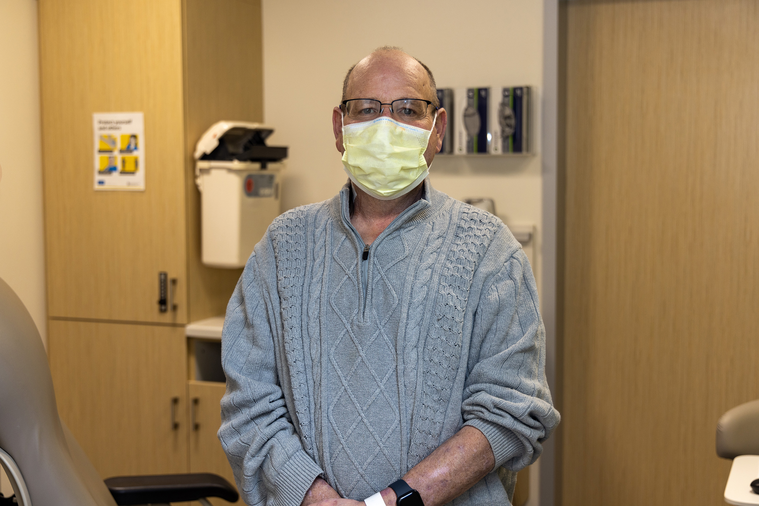 Thad Crane smiling behind mask during a follow up visit